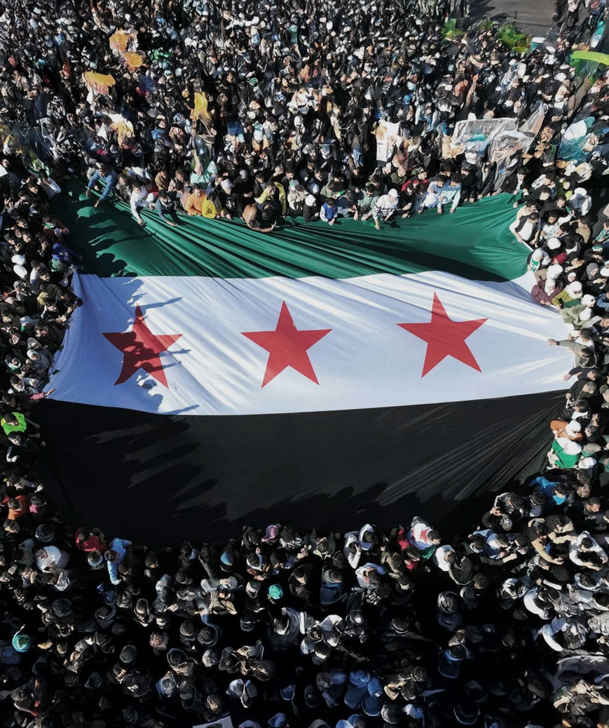 Free Syrian flag raised by celebrators